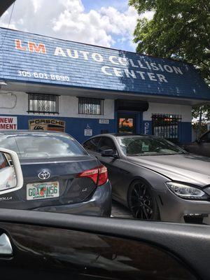 Front of bodyshop and hubby's car.