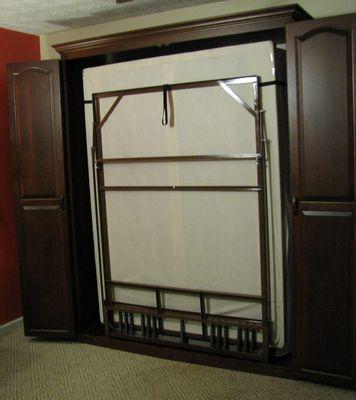 Cherry queen size Murphy bed opened.  Ready for bed to be lowered.