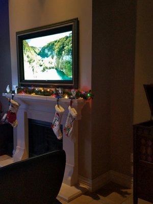 VisionArt moving art with TV on. Decorated for Christmas