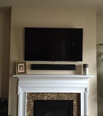 A flat panel television and sound bar installed by Mercer Handyman Services