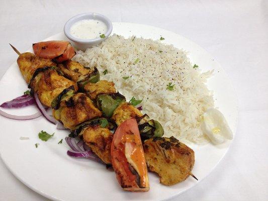 Chicken Kabob Entree comes with Rice, Salad and a side of Hummus and pita bread.