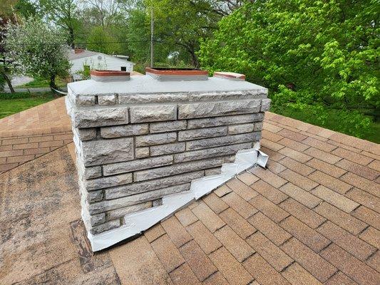 Damaged crown and leaking flashing sealed to give this old chimney protection without requiring major repair costs.