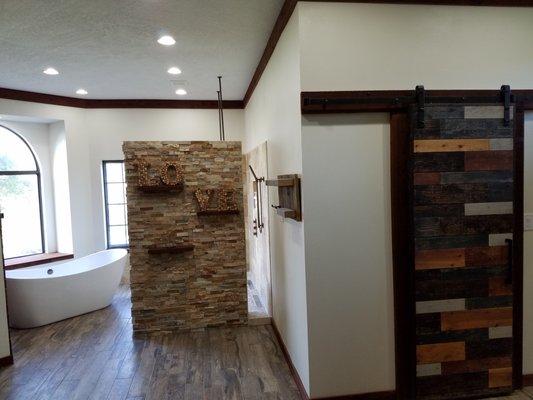 Shower surround with full height privacy wall.