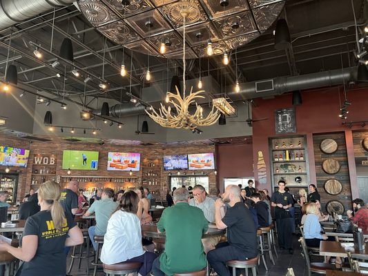 Super cute inside with lots of TVs and seating. Loving the antler chandelier.