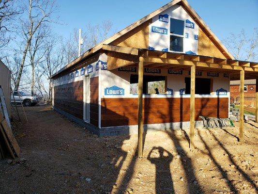 Wood siding, wood trim, window installation