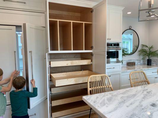 When there's no room for a walk-in pantry the answer is using the height of your wall space and dedicating custom cabinetry.