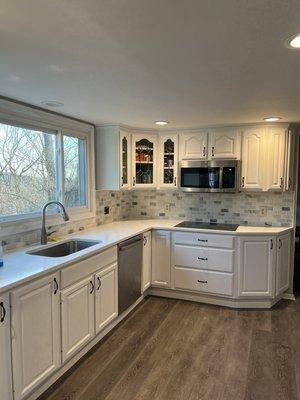 Kitchen cabinets painted from oak to white. Backsplash installed.