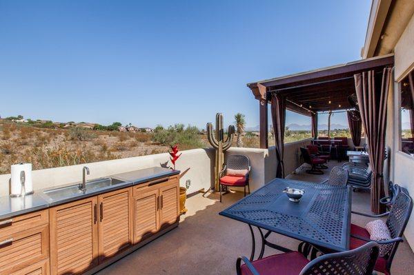 We maximized outdoor living areas with this Deck Renovation and Storage Room Two-Story Addition in North Phoenix.