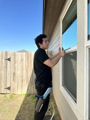 Martin, Cloud 9 Co-Owner, servicing Mrs. Stein's windows.