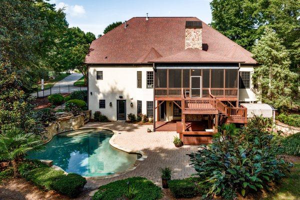 Here is an aerial photo of a beautifully landscaped yard with a pool and kitchen area. www.sixcentsmedia.com