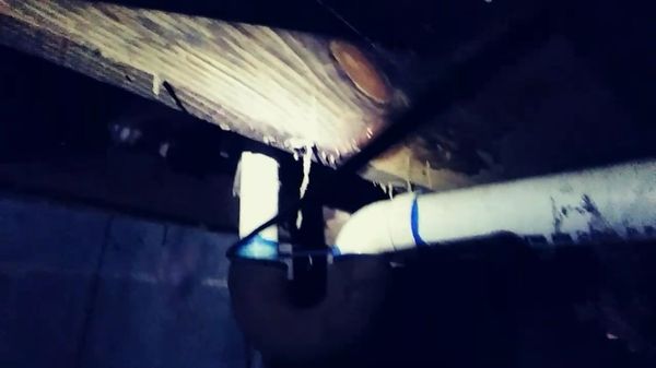 Hanging termite tubes from the floor structure viewed from beneath in a crawl space. It makes sense to have a regular inspection.