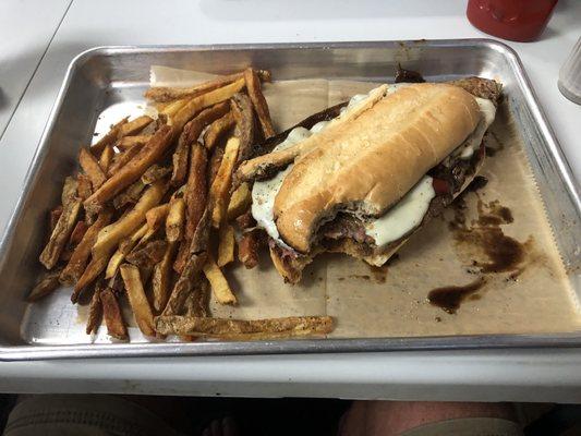 Rib-eye sandwich with fries.