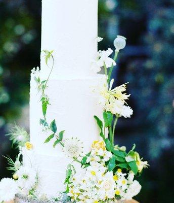 Wild flowers tower wedding cake in buttercream