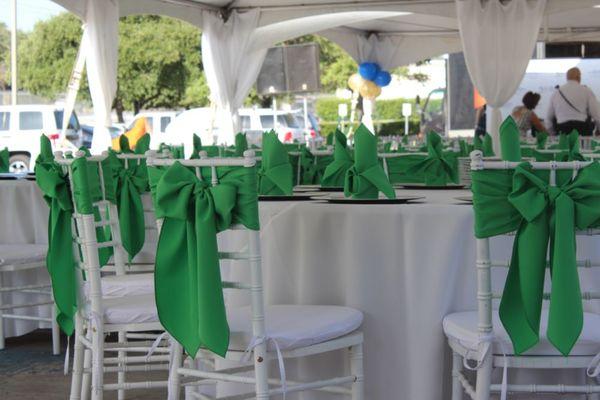 White Chiavari Chair rentals with green sashes.