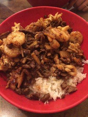 Shrimp, beef, and squid rice bowl topped with Mongolian BBQ sauce