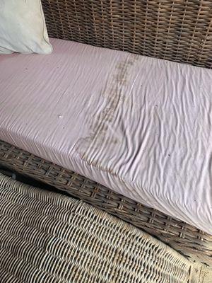 Some of the water damage on hand crafted cushion from power washing company. See review.