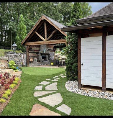 Lawn Turf cut around a flagstone walkway and a small 300SF sand filled putting green.