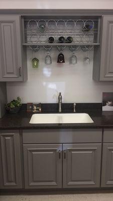 I am in love with these grey kitchen cabinets with the wine rack and glass holders.