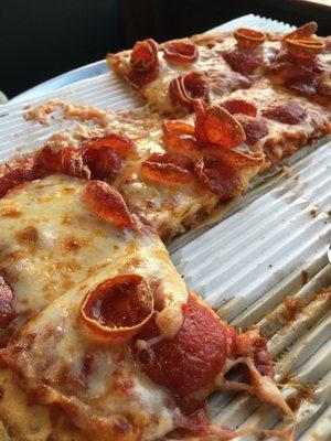 This the crispy thin with old world pepperoni. It is a round pizza cut into squares.