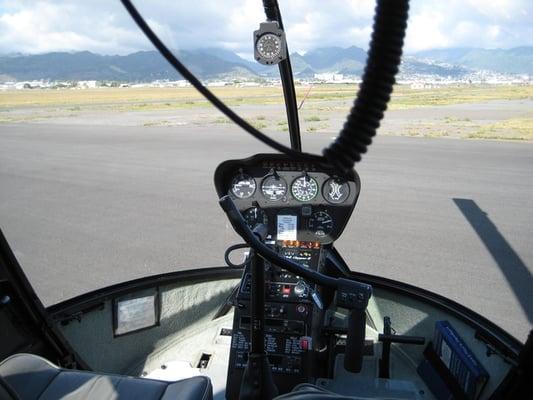 Sitting inside a Robinson R44, the world's most popular helicopter.