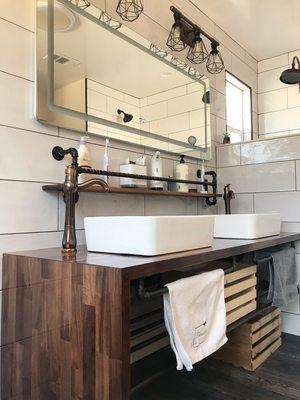 Wooden Waterfall vanity with iron pipe hardware for industrial look