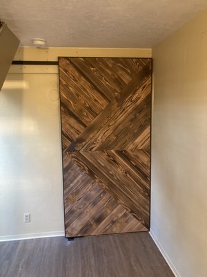 Sliding barn door with Shou Sugi Ban finish in triangle pattern.