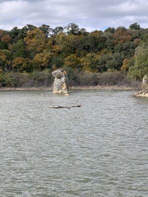 A big rock sticking out of the river