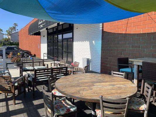 Shaded sitting area on deck outside of front entryway