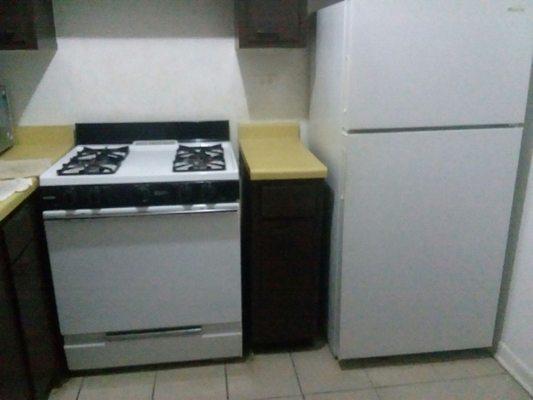 Ensembled with stove and refrigerator