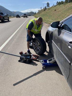 Billy examining my tire to see if it can be fixed on the spot.