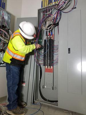 My partner cleaning up the panel for new branch circuits being installed.