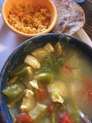 Large bowl of chicken soup, rice & wheat tortillas.