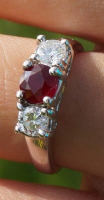 Ruby with two diamonds on white gold.