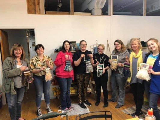 Workshop attendees with their finished woven tapestries