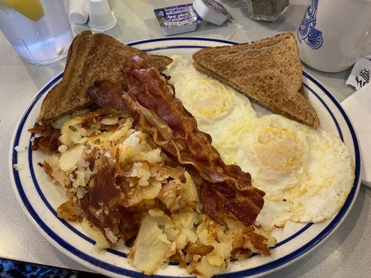 Eggs, bacon, toast, and potatoes