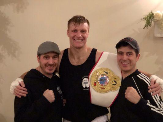 Jason Orlando (Center) showing off his Marciano Championship with coaches Mark (left) and Matt (right)