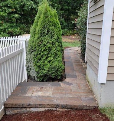 Wrap-around patio on the left side of the house.