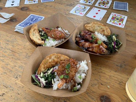 Coconut shrimp, pot stickers, teriyaki chicken. On a bed on Asian slaw and white rice.