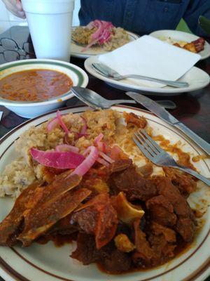 Mashed green plantains (Mangu), stewed goat, marinated pink onions, bean stew, coffee.  All very good.