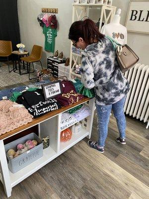 A customer looking over the selection of graphic tees