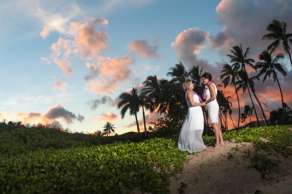 Waialae Beach Park at sunset.  Stunning sunset appeared for these ladies to complete their wedding day.