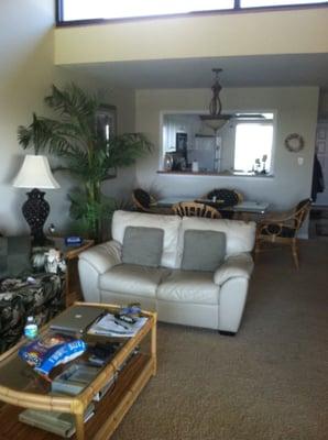 An open floor plan with the kitchen window passthrough leading to the dining area, and living room.