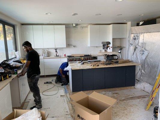 The window being installed and the appliances going into place.