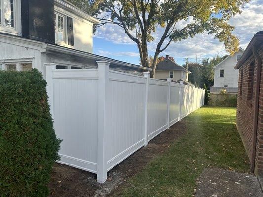 White vinyl side yard privacy and pet enclosure