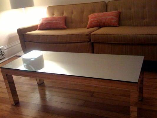 Sexy-smooth mirrored coffee table was made with a little help from Compass Glass