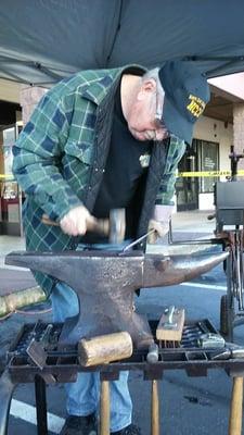 Jim Brimble demonstrating blacksmith techniques live.