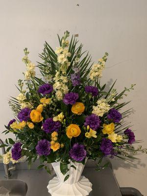 Stock, Runuculus, Spray Roses, Larkspur, Carnations, and Mixed Greens in a basket