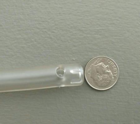 This photo shows the clean water inflow nozzle compared to a dime. The actual outer diameter of the nozzle is 3/8 inch.