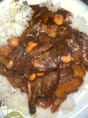 Brown stew shrooms with white rice.