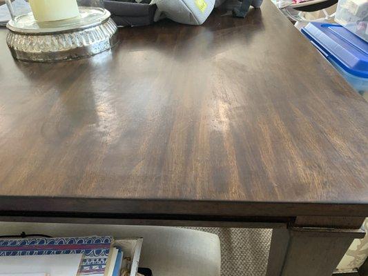 Whatever was used to clean my wooden dining room table left a milky, streaky residue.